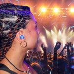 Person with braided hair at a concert with bright lights and crowd in the background