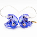 A pair of in-ear monitors with translucent blue plastic housings and silver wire leads, shown on a clean white background.