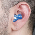 blue earplug in ear with dark hair around it