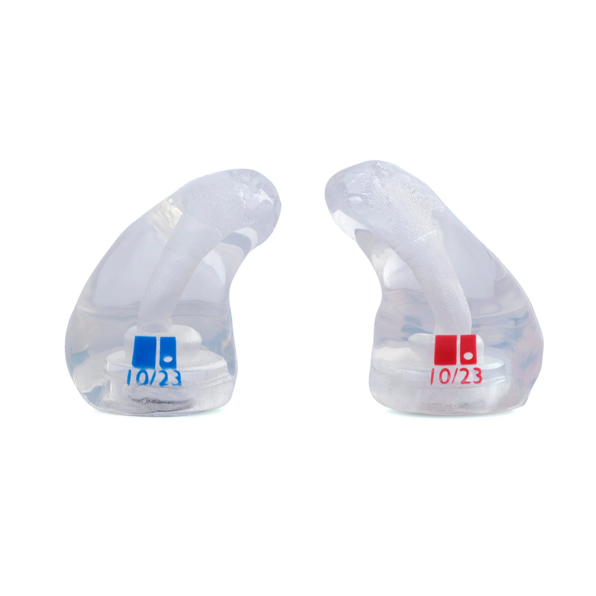 Clear earbud tips with date labels on a white background