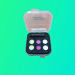 Small open box with colorful buttons on a green background