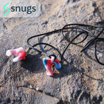 multi coloured earplugs sitting on a rock with cording attached. "snugs" logo above the earplugs.