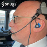 man wearing Bose aviation headset with snugs earplugs whilst flying plane