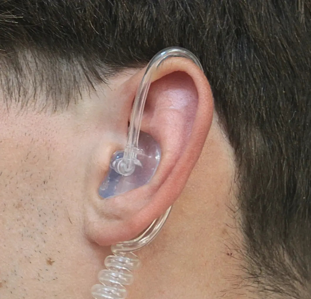 human ear with clear earplug and coil wiring.