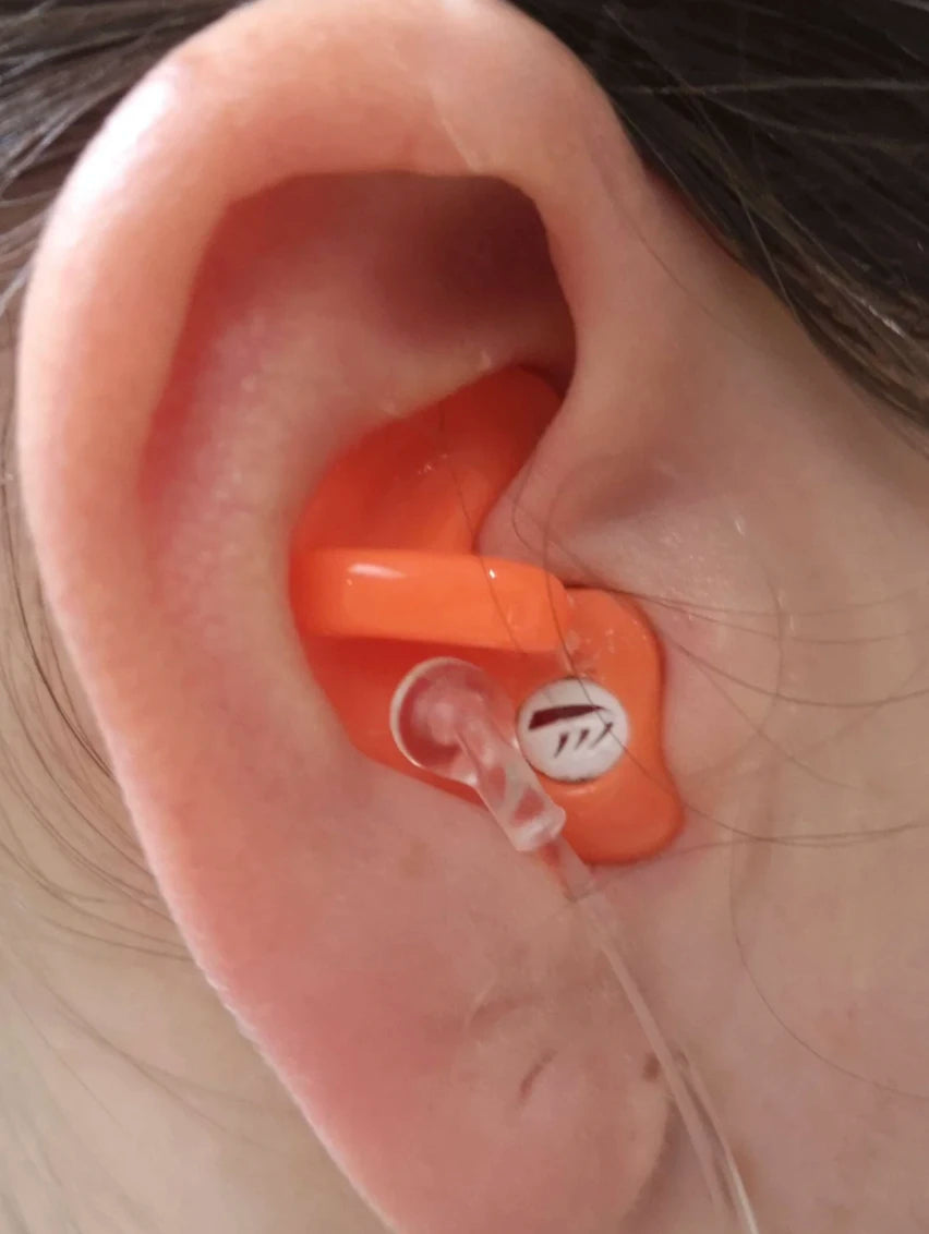 Orange earplug inside a person's ear